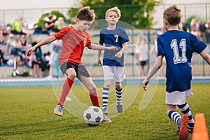 Young boys playing soccer game. Training and football match between youth soccer teams