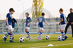Young Boys in Sports Club on Soccer Football Training. Kids Enhance Soccer Skills on Natural Turf Grass Pitch photo