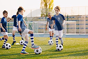 Young Boys of Sports Club on Soccer Football Training. Kids Improving Soccer Skills on Natural Turf Grass Pitch