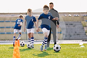 Young Boys in Sports Soccer Club on Training Unit. Kids Improve Soccer Skills on Natural Turf Grass Pitch