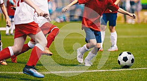 Young Boys in White and Red Soccer Jersey Shirts and Soccer Cleats Kicking Soccer Ball