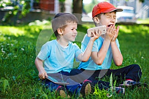 Young boys with wireless smartphone and tablet goodwill