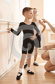 Young boys working at the barre in a ballet dance class.