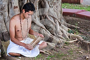 Young brahmin reads scripture photo