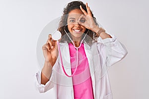 Young brazilian doctor woman using stethoscope standing over isolated white background with happy face smiling doing ok sign with