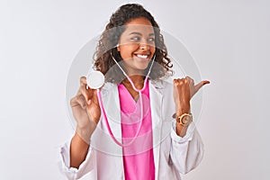 Young brazilian doctor woman using stethoscope standing over isolated white background pointing and showing with thumb up to the