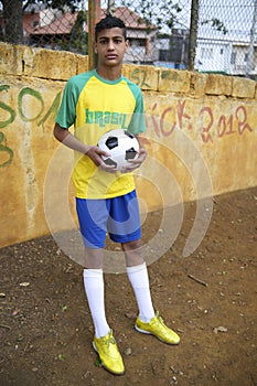 Young Brazilian Football Player Holds Soccer Ball