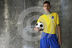 Young Brazilian Footballer in Kit Holding Football