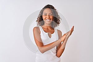 Young brazilian woman wearing casual t-shirt standing over isolated white background clapping and applauding happy and joyful,