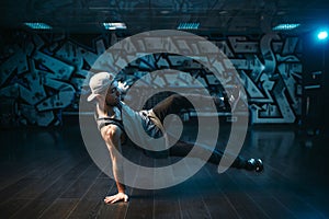 Young breakdance performer dancing in studio