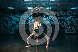 Young breakdance performer, upside down motion