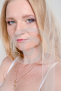 Young bride girl in lingerie and lace veil