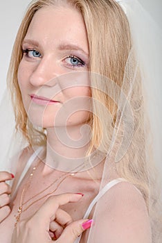 Young bride girl in lingerie and lace veil