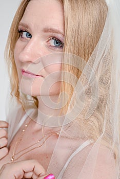 Young bride girl in lingerie and lace veil