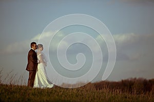 Young bride groom against blue sky clouds