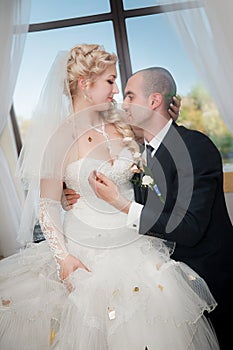 Young bride and groom in banqueting hall photo