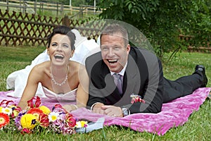 Young bride and groom lying together