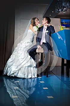 Young bride and groom next to bar