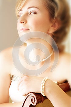 Young bride with large green eyes and pearls