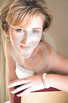 Young bride with large green eyes and pearls