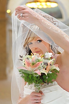 Young bride looking out window