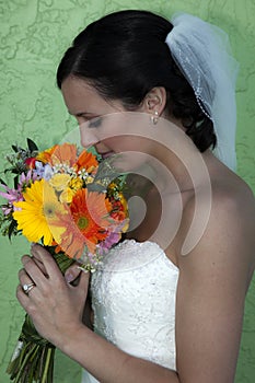 Young bride profile holding flowers