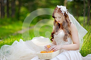 Young bride sitting on a grass