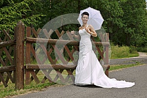 Young bride with sunshade