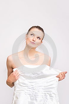 Young bride-to-be trying on her gown - checking the dress