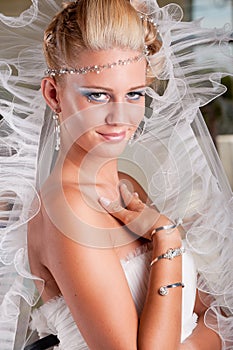 Young bride in white dress with tiara and veil