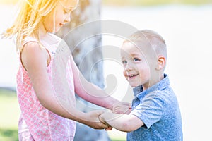 Young Brother and Sister Spinning At The Park photo