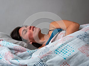 Young Brown Hair Hispanic Female Snores while Sleeping in her Be