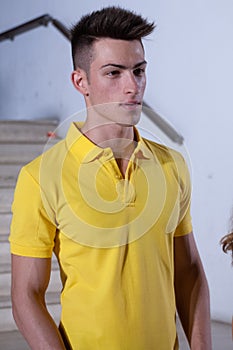 Young brown hair male model with yellow polo shirt