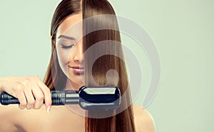 Young woman is demonstrating process of hair straightening. photo