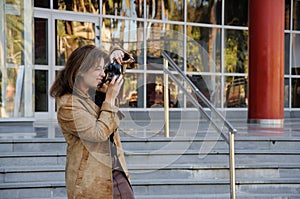 Young brown haired woman photographing