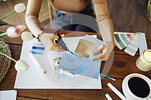 Young brunette african american woman creating her Feng Shui wish map using scissors