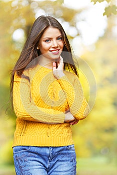 Young brunette in autumn park