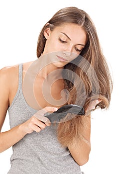 Young brunette beautiful lady combing long hairs