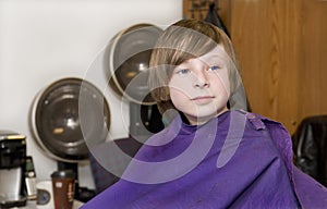 Young brunette boy at hair salon