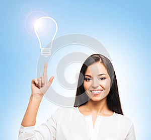 Young brunette businesswoman with an idea bulb