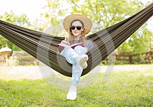 Young brunette is chilling in the hammock