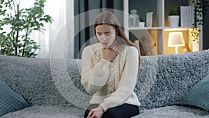 Young brunette coughing at home