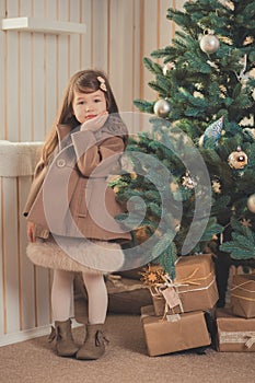 Young brunette dolly lady girl stylish dressed cozy warm winter gray jacket with fur posing sitting standing in studio close to Ch photo