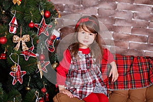 Young brunette dolly lady girl stylish dressed in red dress costume chequers check tartan skirt strap shoes smiling posing sitting