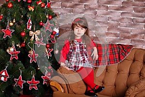 Young brunette dolly lady girl stylish dressed in red dress costume chequers check tartan skirt strap shoes smiling posing sitting