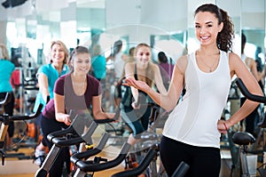 Young brunette in exercise bikes class