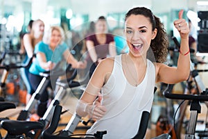Young brunette in exercise bikes class