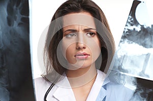 A young brunette female doctor with an xray