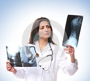 A young brunette female doctor with an xray