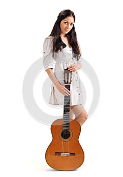 Young brunette girl with acoustic gui